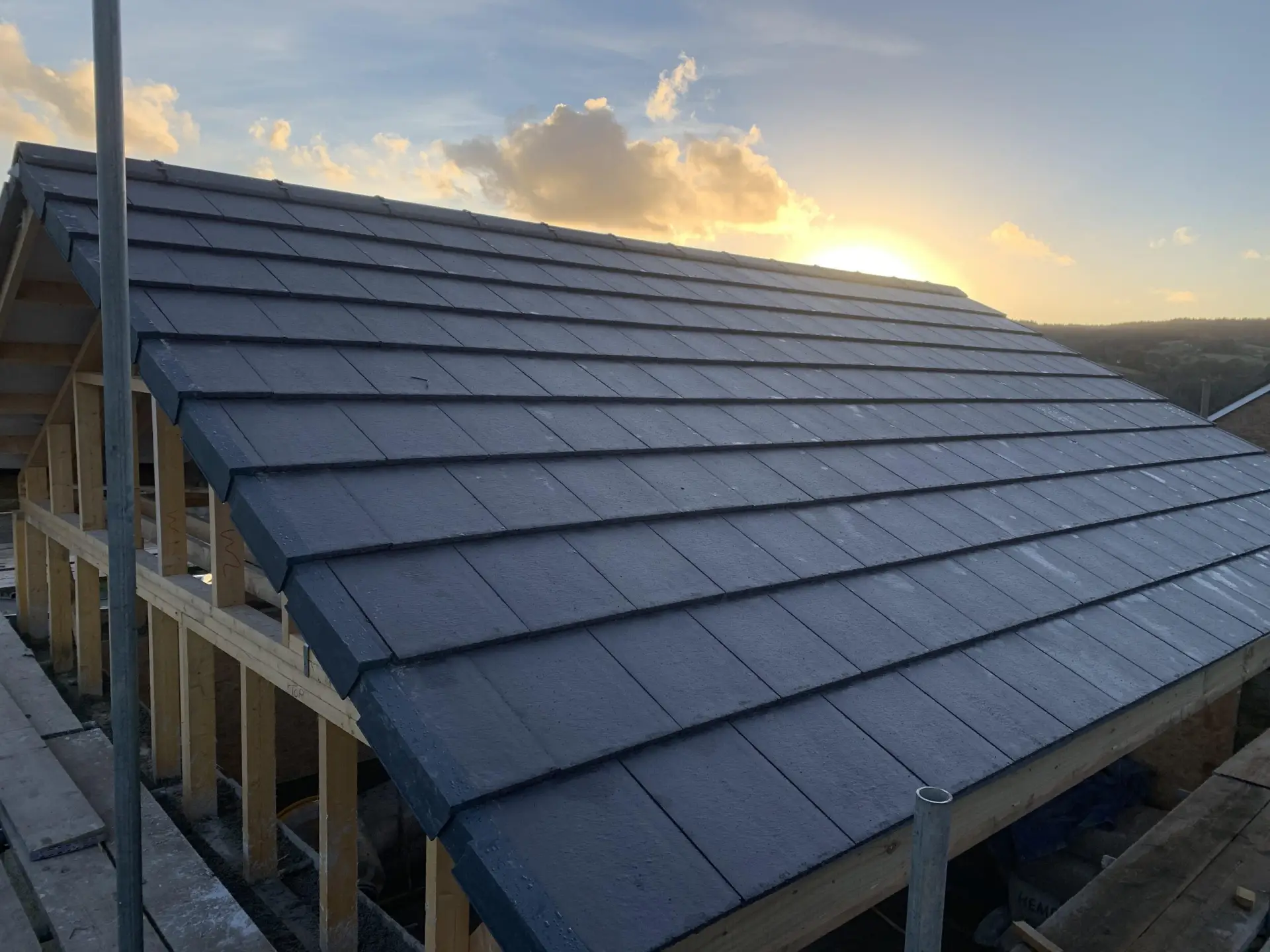 New Wellspring roof under construction at sunset